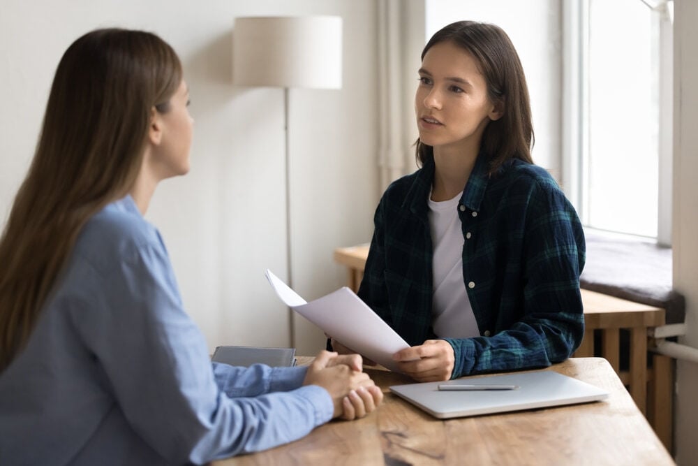 project manager woman in casual informal clothes talking to female business colleague